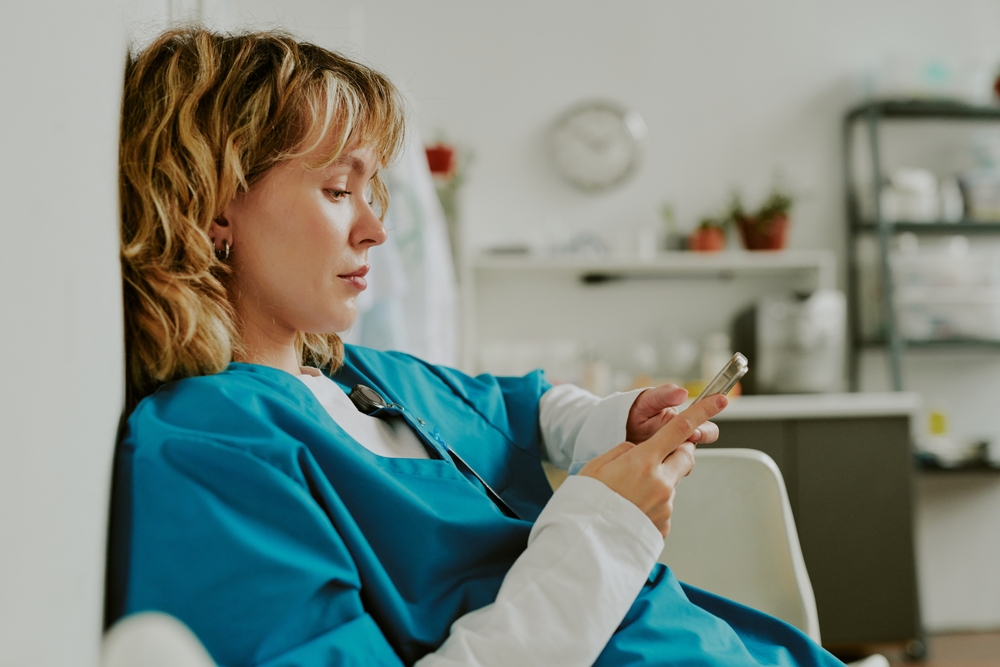 Young nurse on her cell phone